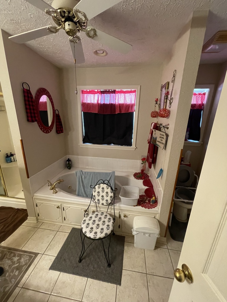 Before: a jetted tub with a window above it