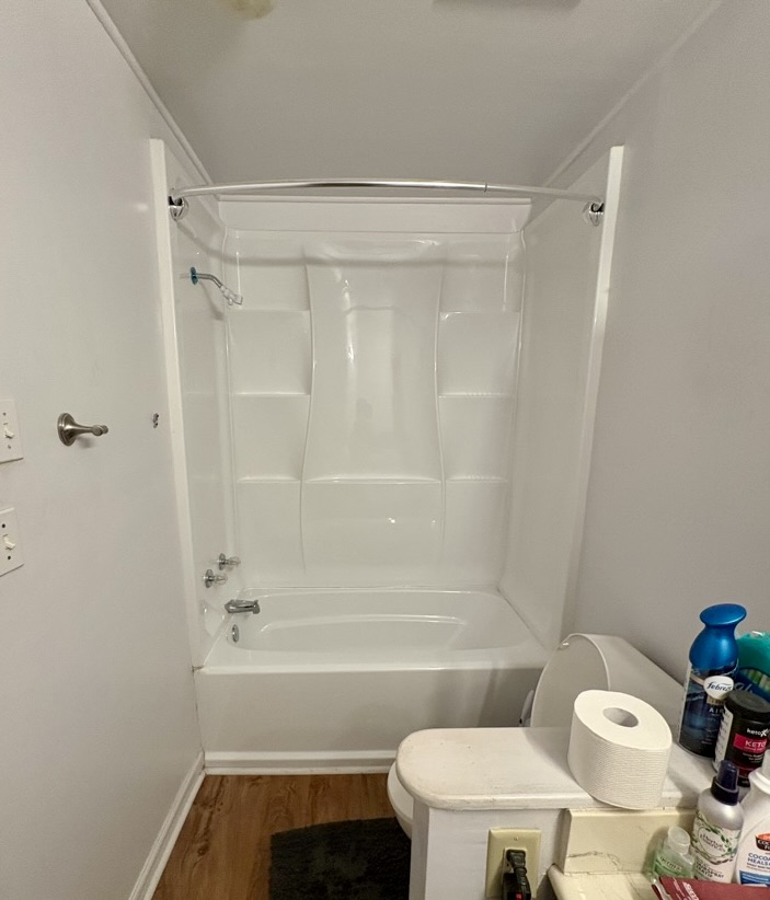 Before: a white fiberglass tub and shower combination