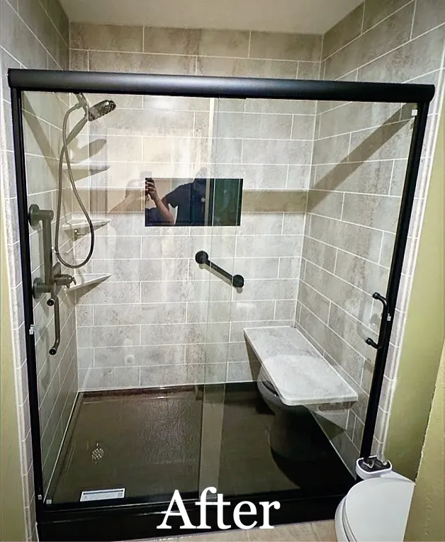 After: AFTER: gray patterned walk in shower, black frame, bench