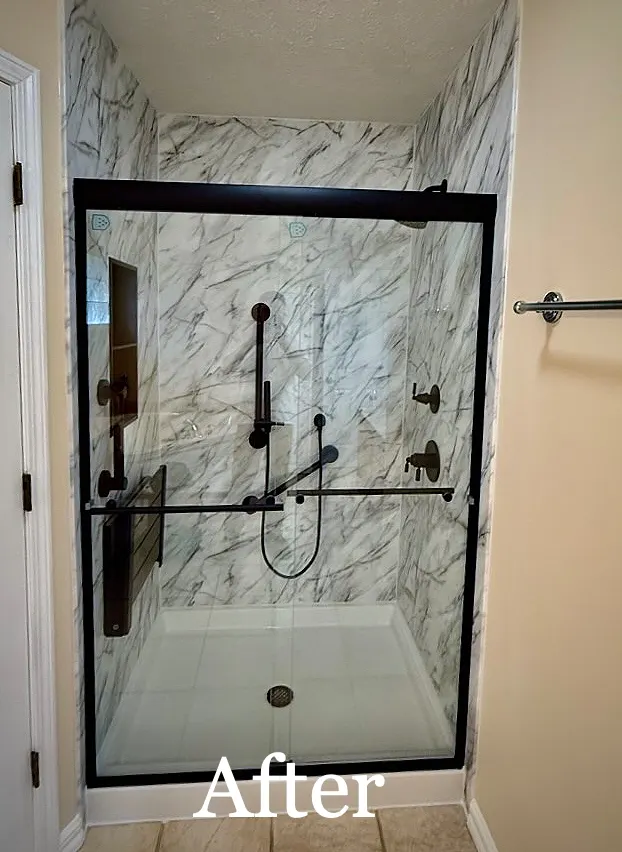 After: AFTER: marble look walls, black framed sliding door