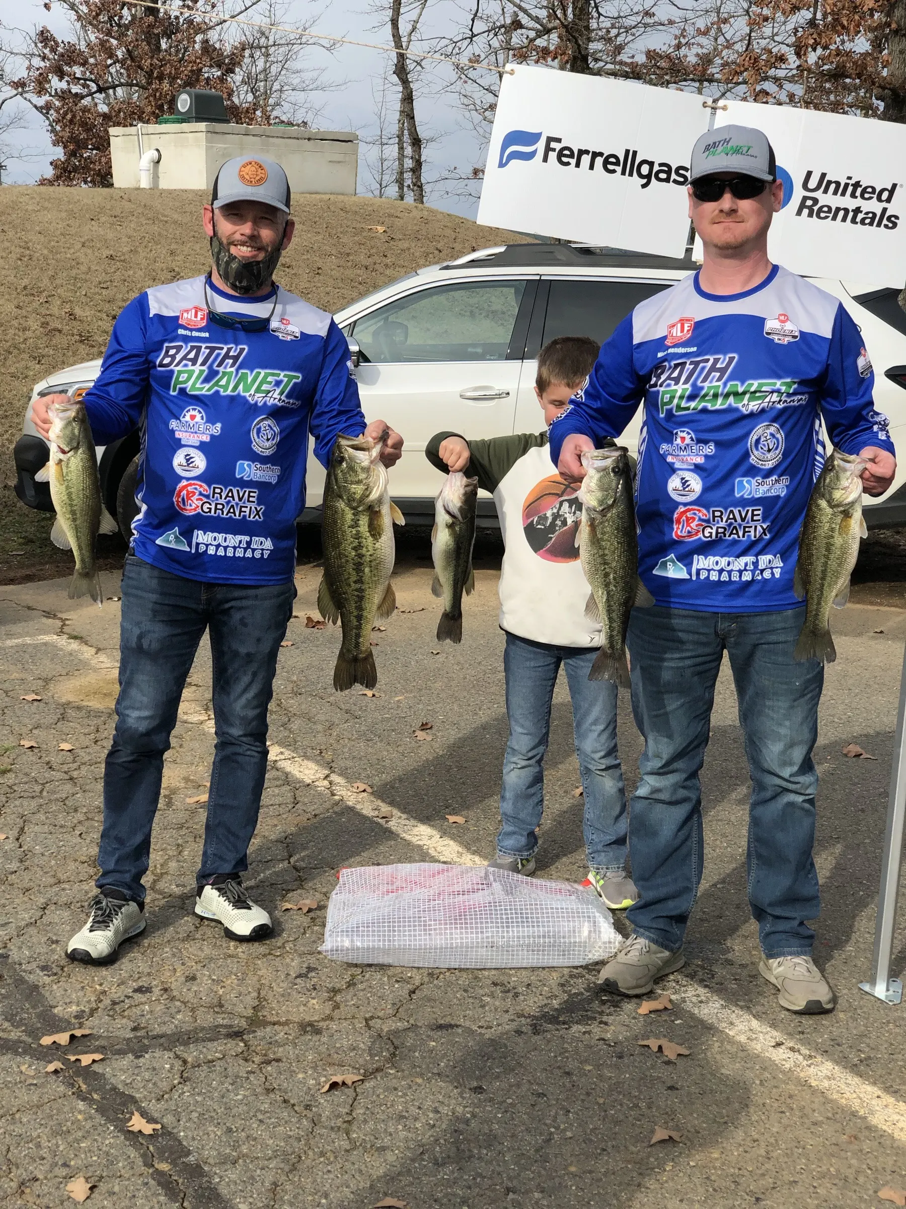 Bath Planet of Arkansas sponsored bass team and a young fan at a tournament weigh in