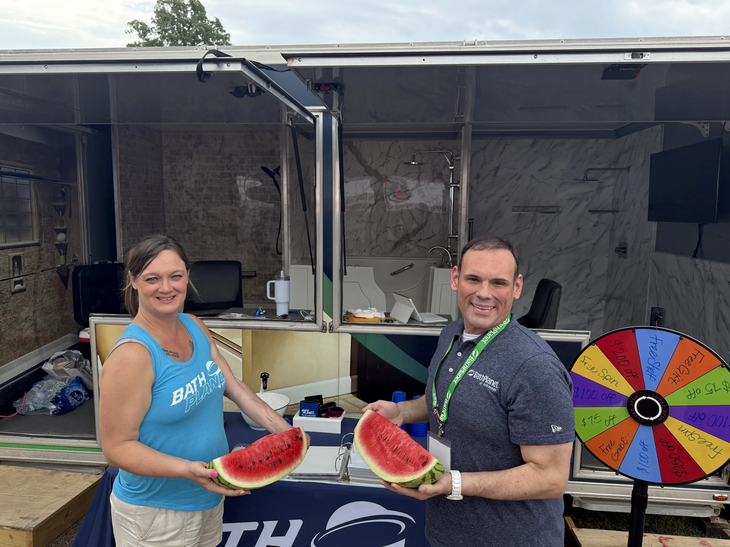 Bath Planet of Arkansas team sharing watermelon at the mobile showroom, Hope Watermelon Festival