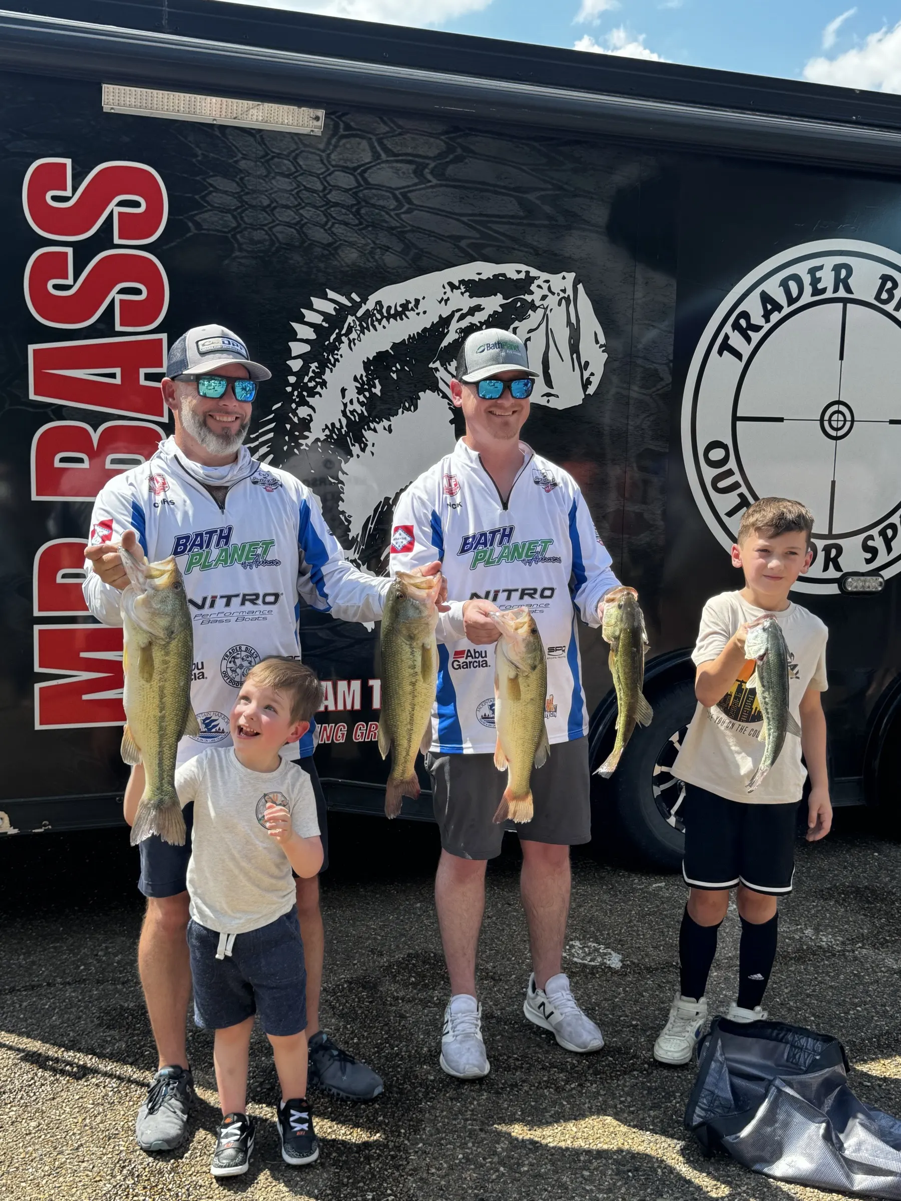 Bath Planet sponsored bass anglers and kids showing their catch at a tournament