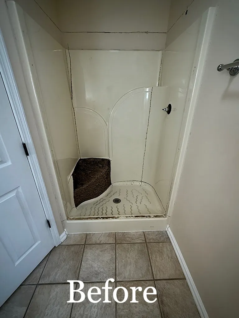 Before: BEFORE: dated fiberglass shower stall