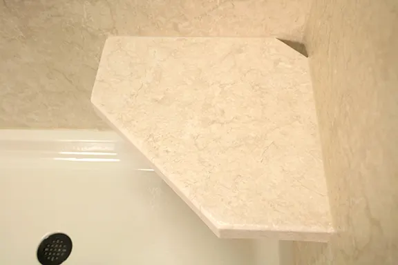 Beige corner shower seat in tub