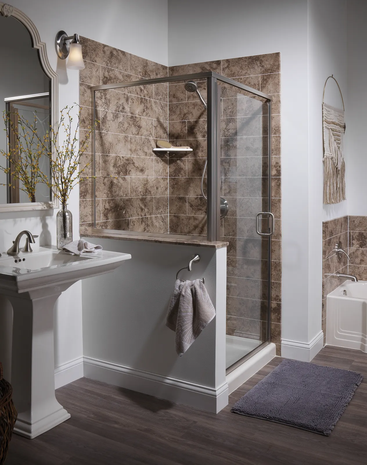 Brown stone look shower with glass door, pedestal sink