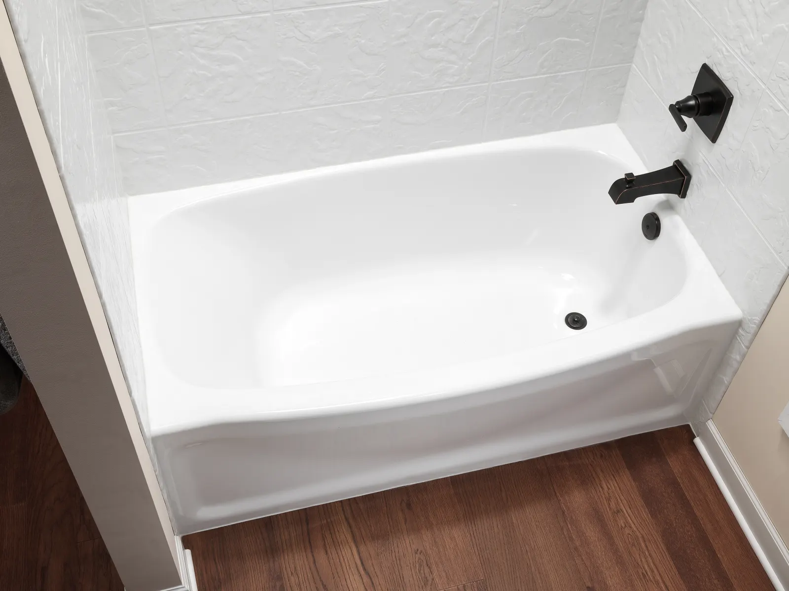 Close up white tub with black faucet trim