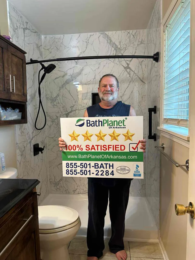 Customer holding 100% SATISFIED sign in finished shower