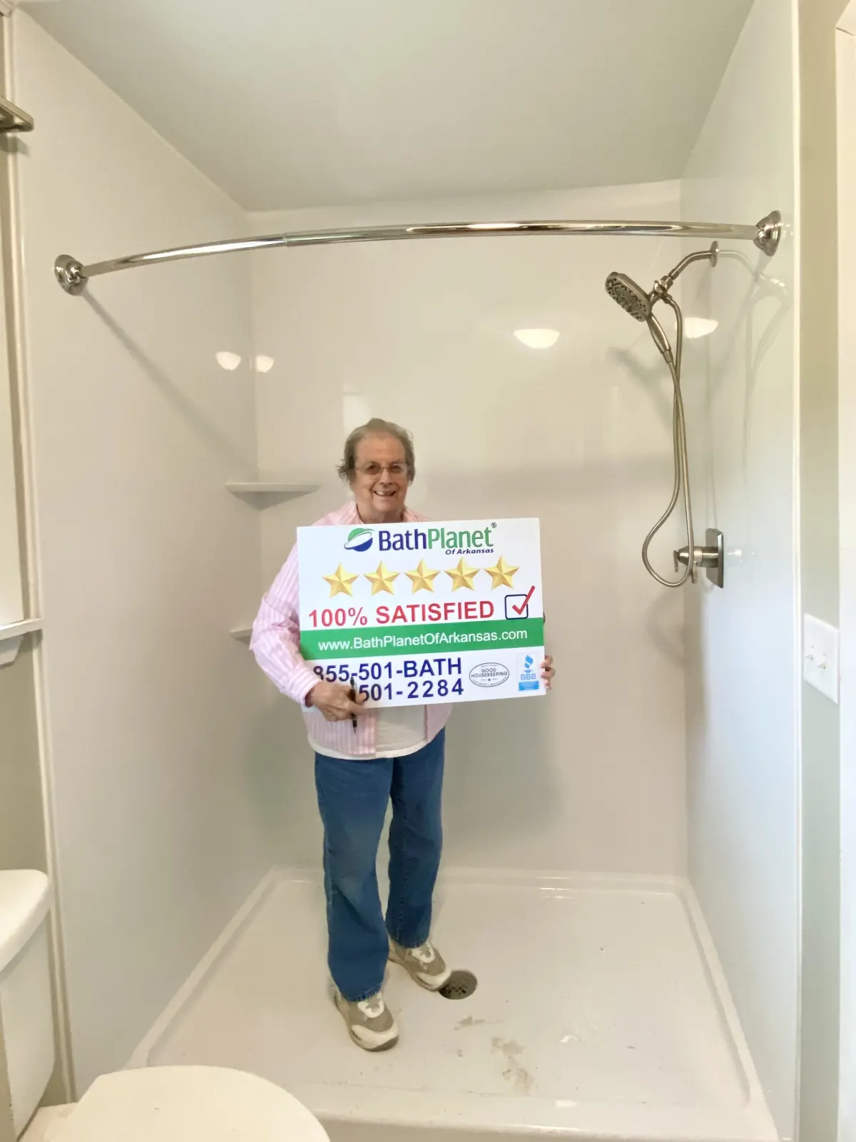 Customer in new shower with sign