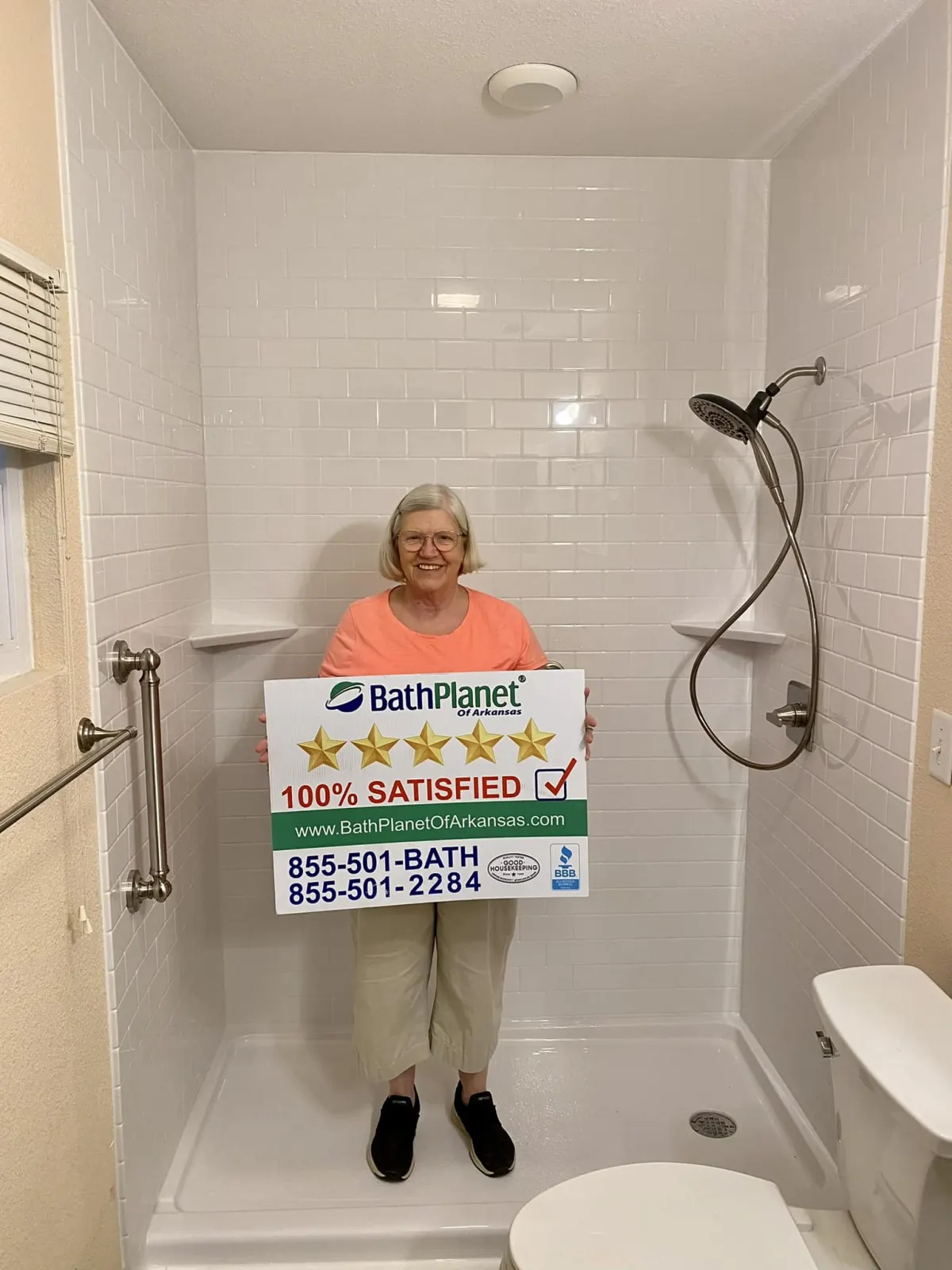 Customer in new white shower with sign
