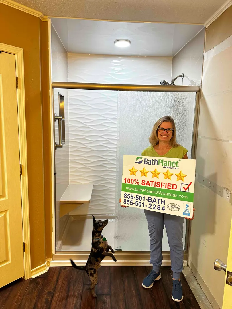 Customer with 100% SATISFIED sign, small dog