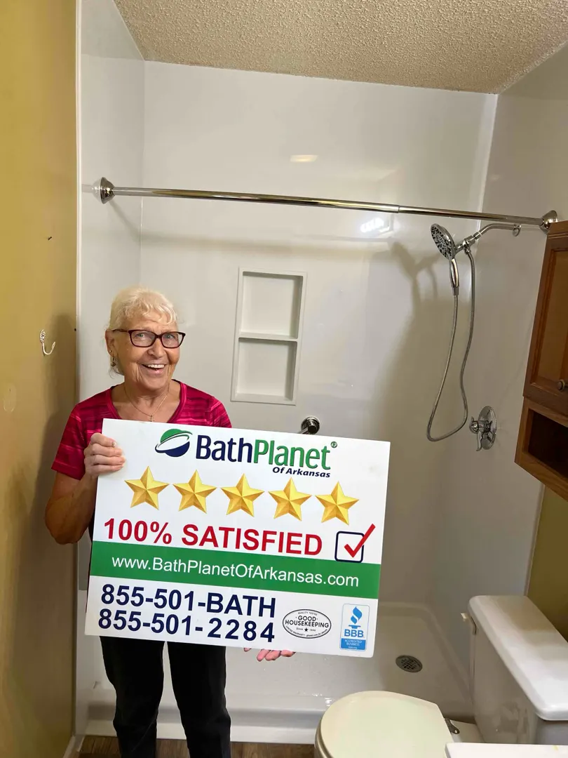 Customer with 100% SATISFIED sign, white shower