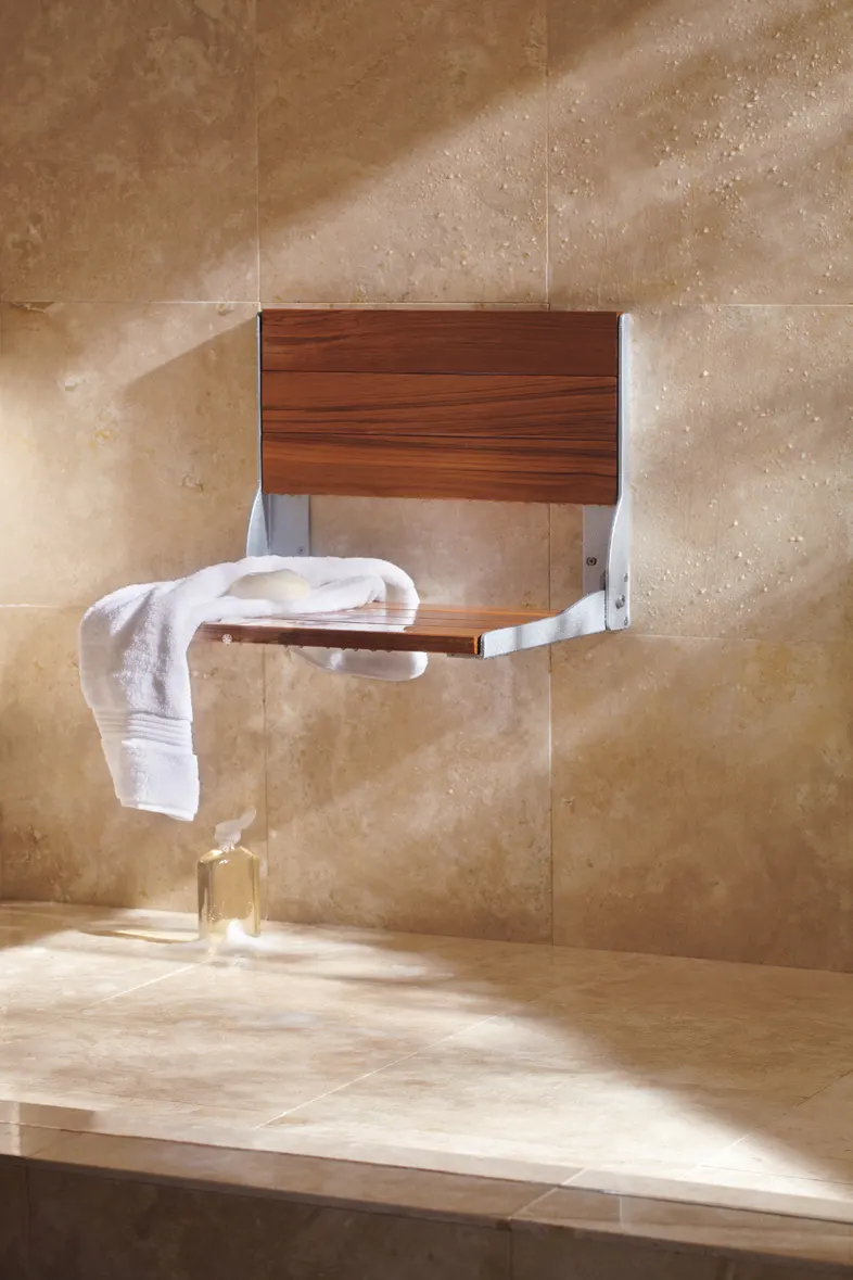 Fold down teak shower seat with towel