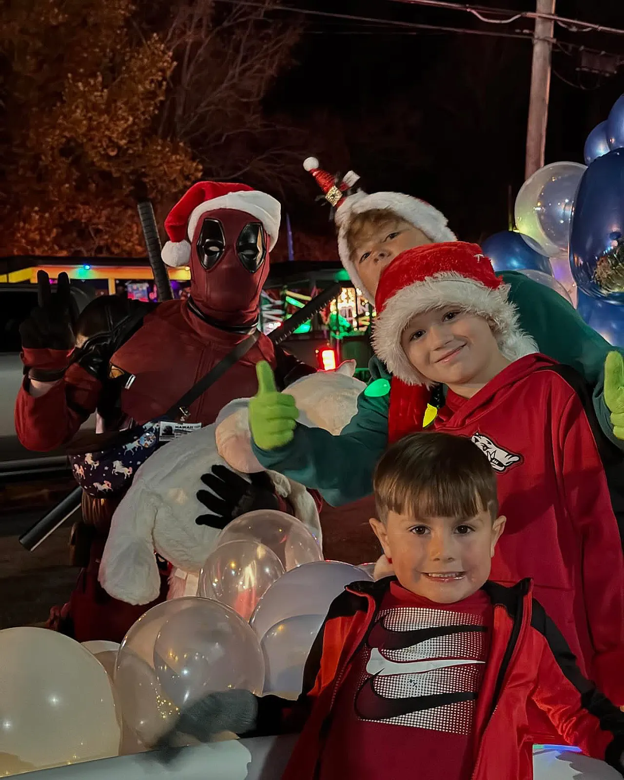 Kids and Santa and costumed characters at holiday event