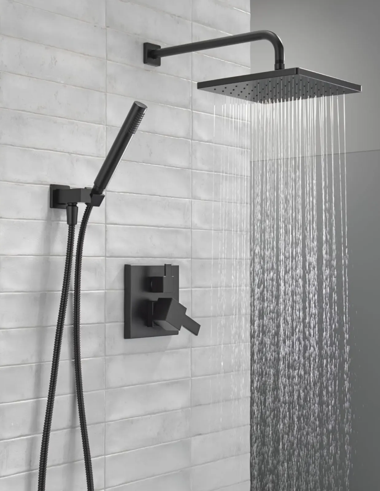 Matte black rain shower head + handheld on white subway pattern