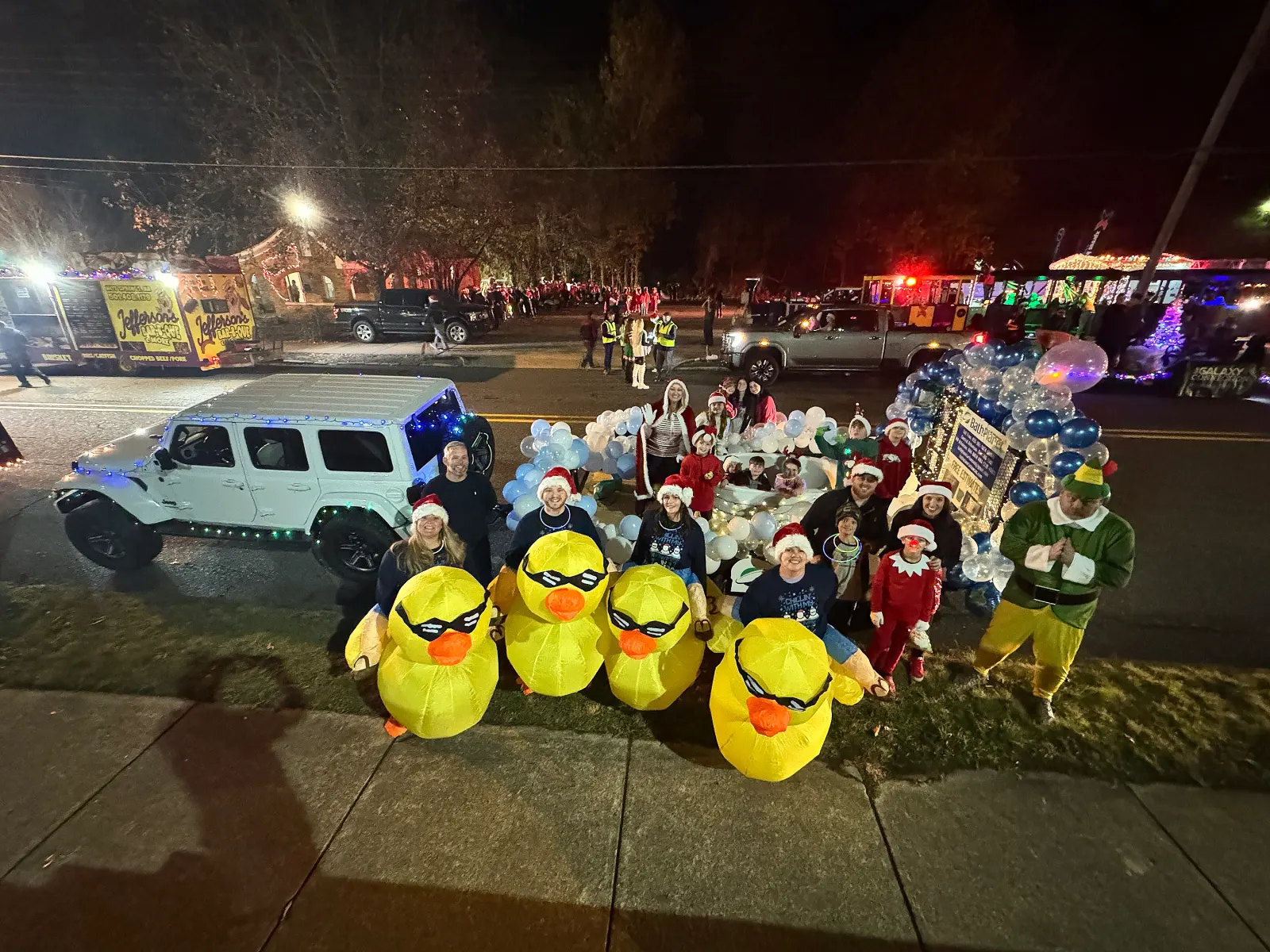 Night parade, team in inflatable duck costumes with Jeep