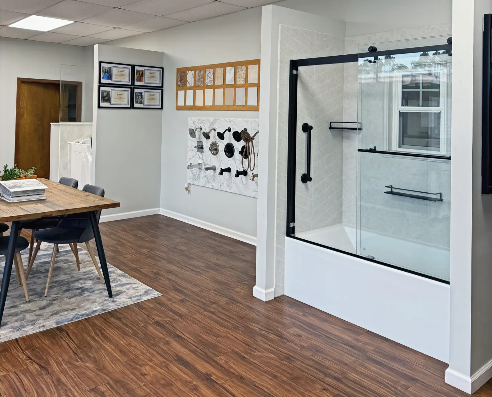 Showroom: black framed tub shower door display