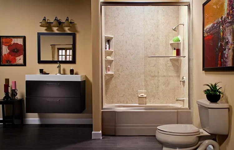 Tan walk in shower beside a floating vanity
