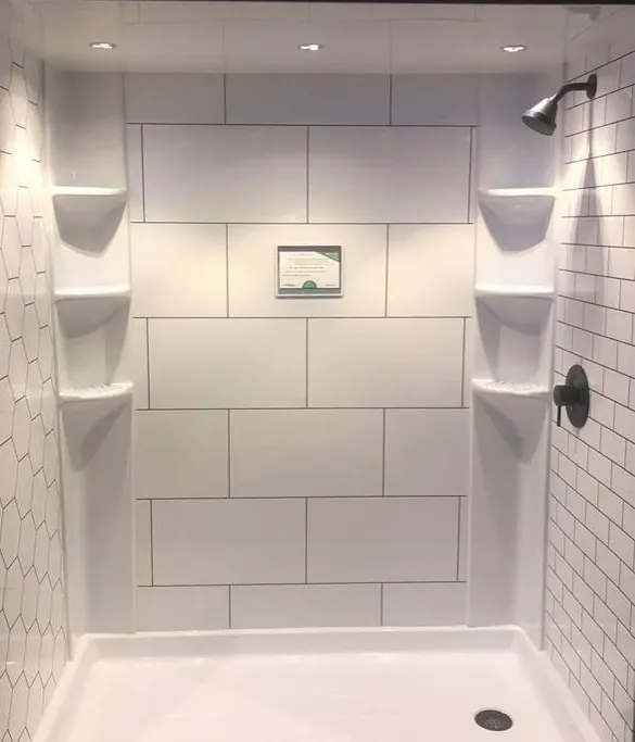 White shower with corner shelves and niche