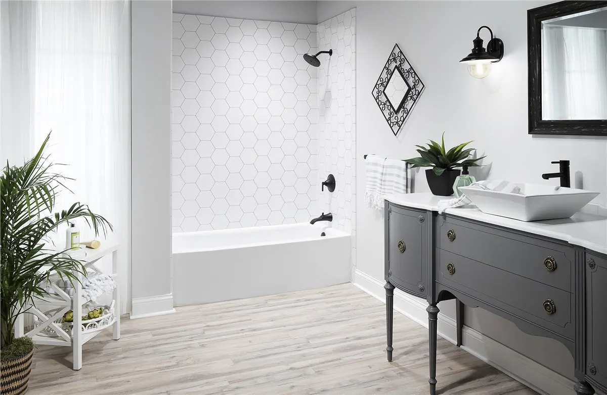 White tub with black fixtures, gray vanity